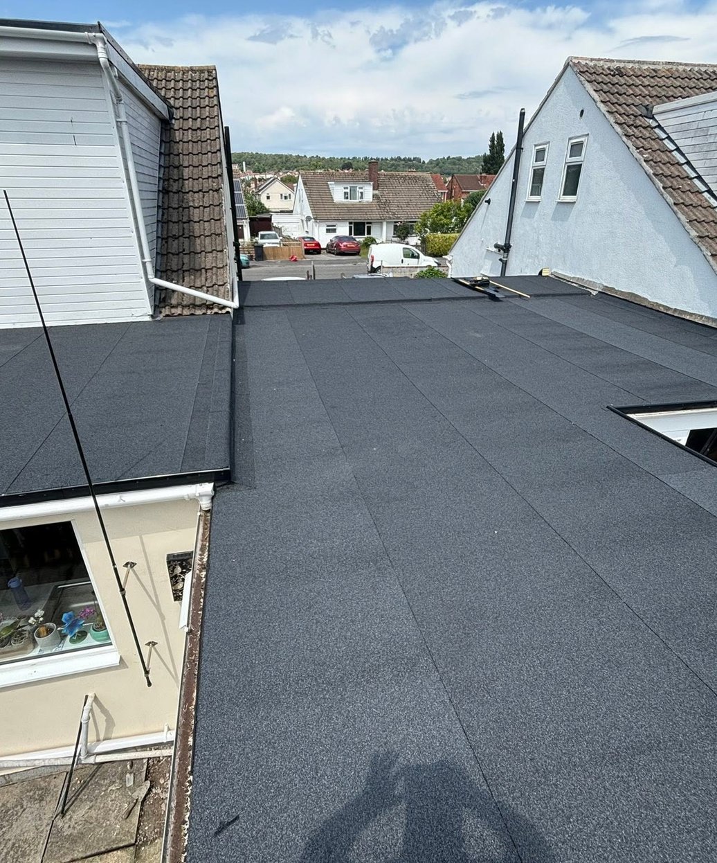 Finished flat roof spanning the rear of adjoining homes