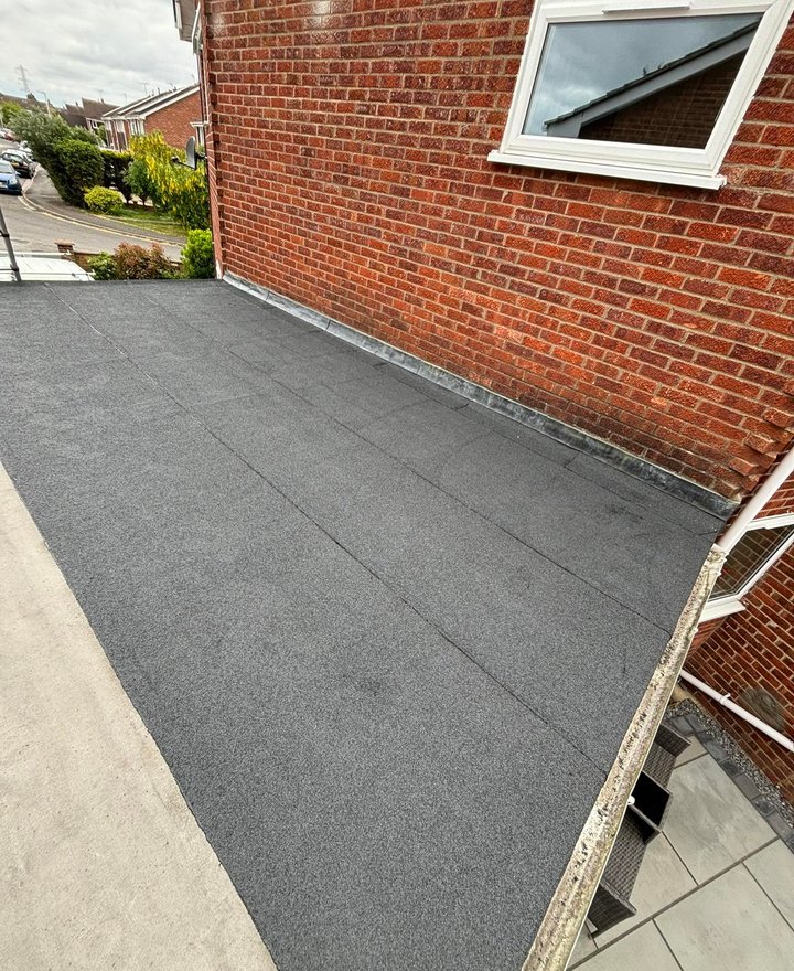 Finished flat roof adjoining a brick home