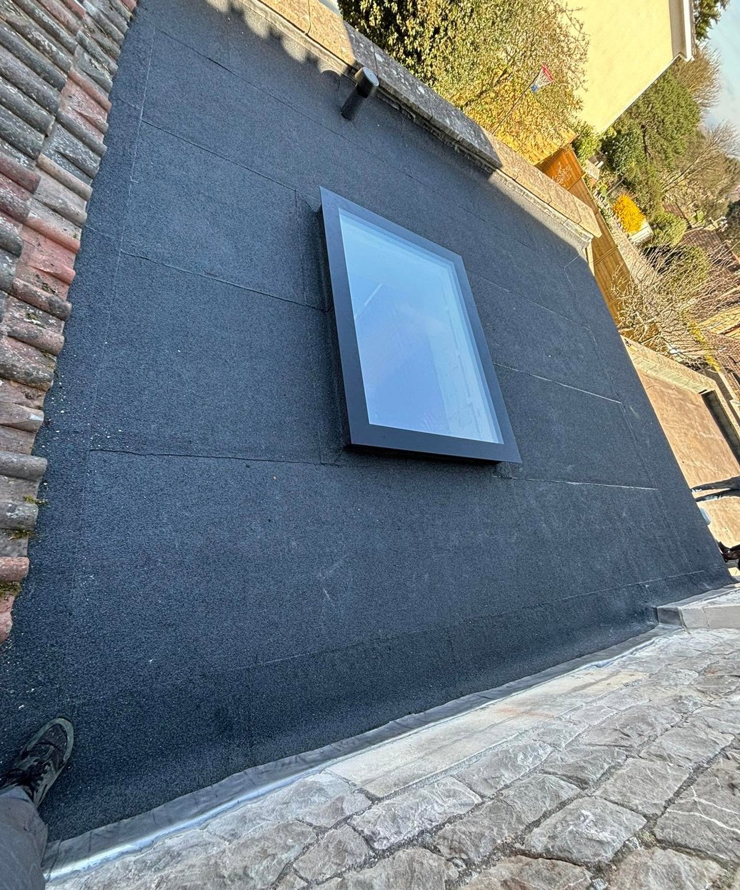 Felt flat roof finished around a rooflight
