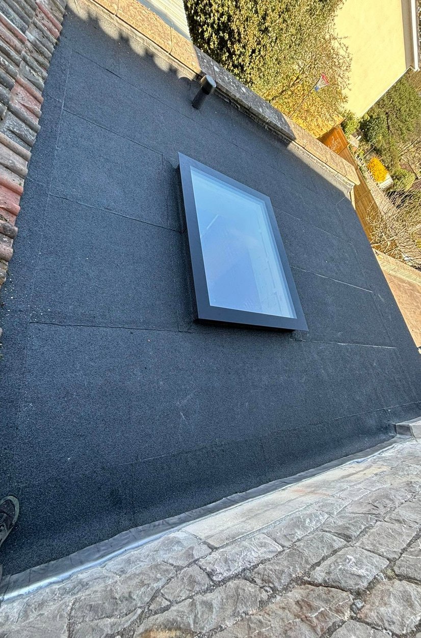 Felt flat roof finished around a rooflight