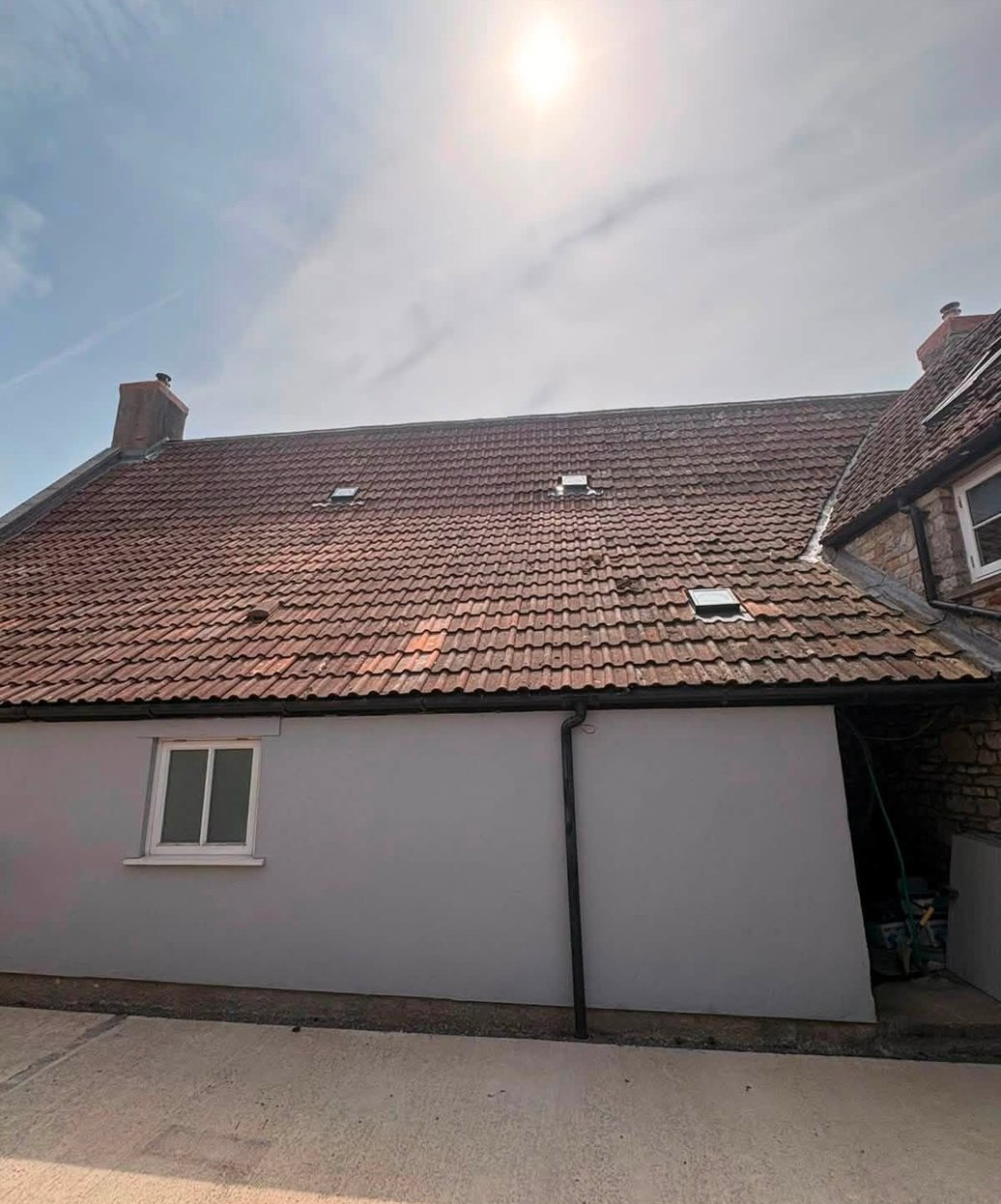 Tiled roof with roof windows and chimneys
